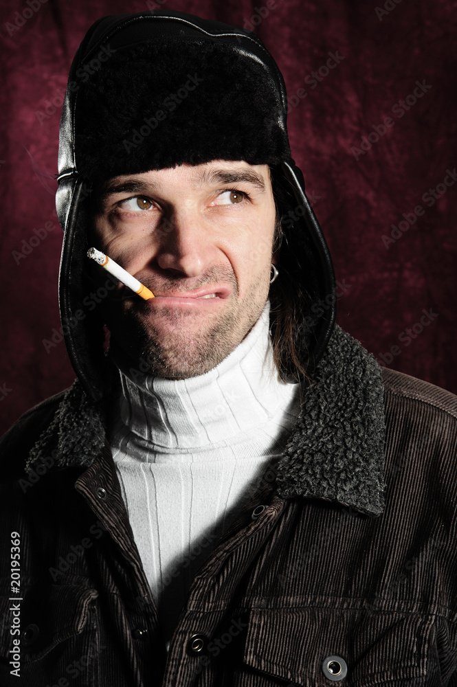 crazy man with cigarette and coat cap crazy man with cigarette and coat cap