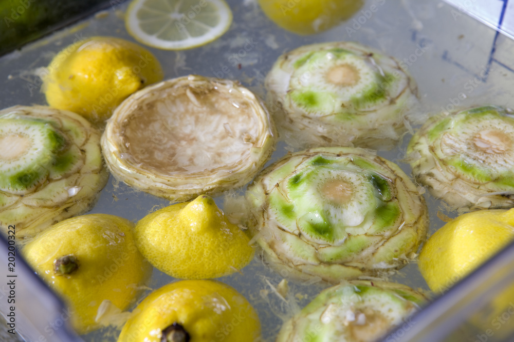 artichoke and lemon in water . preparation of pie artichoke and lemon in water . preparation of pie