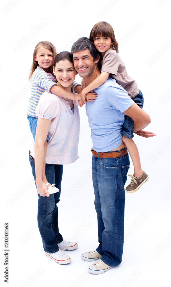 Loving parents giving their children a piggyback ride Loving parents giving their children a piggyback ride