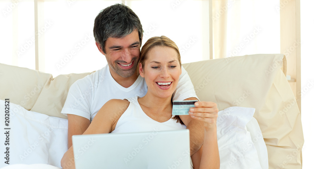Affectionate couple buying on internet Affectionate couple buying on internet