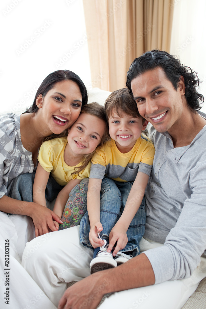 Portrait of an affectionate family sitting on sofa Portrait of an affectionate family sitting on sofa