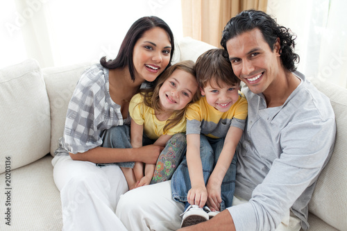 Joyful family sitting on sofa © WavebreakMediaMicro