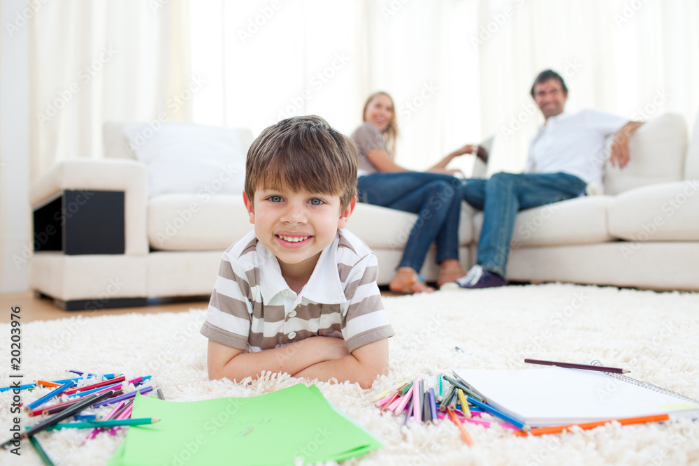 Adorable little boy drawing lying on the floor Adorable little boy drawing lying on the floor