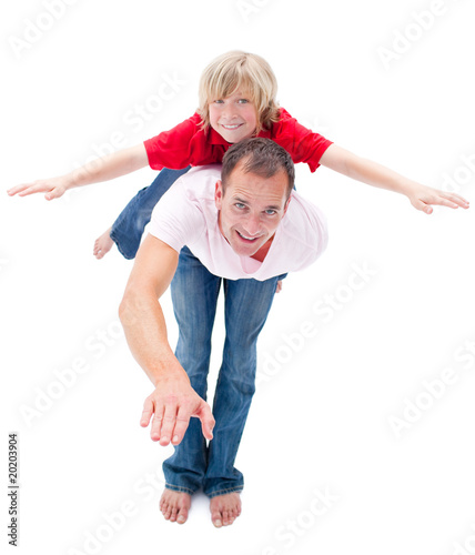 Adorable child enjoying piggyback ride with his father