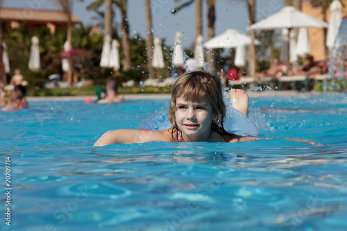little girl floating in the pool