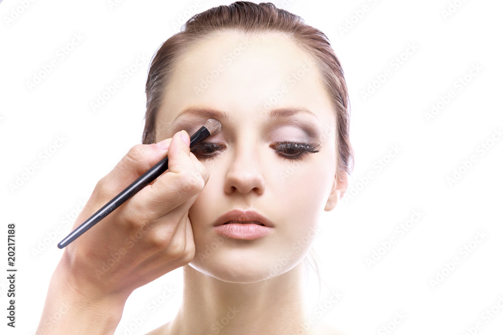 Portrait of attractive young woman applying blusher. Portrait of attractive young woman applying blusher.