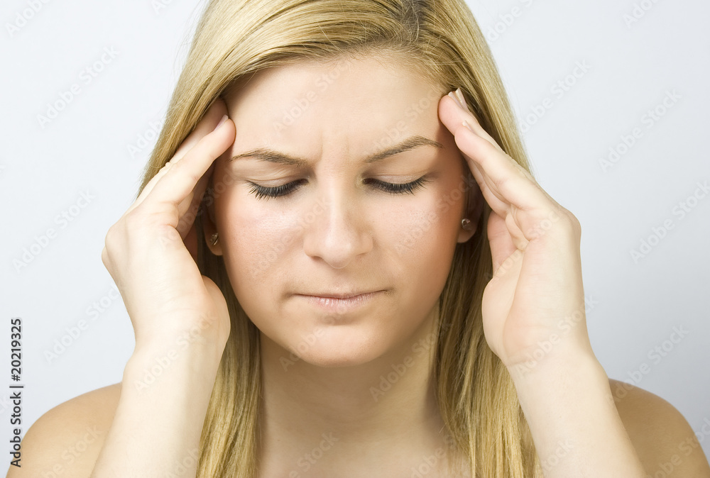 young woman with severe headache, holding hands to head young woman with severe headache, holding hands to head