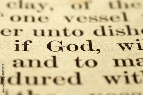Shallow focus on the word God in a vintage Bible.