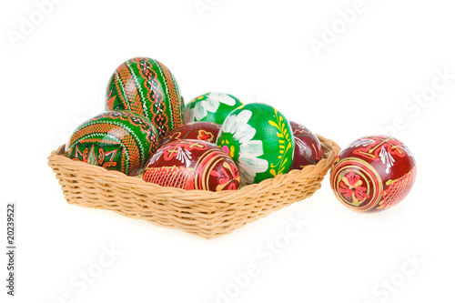Group of colored easter eggs in basket isolated