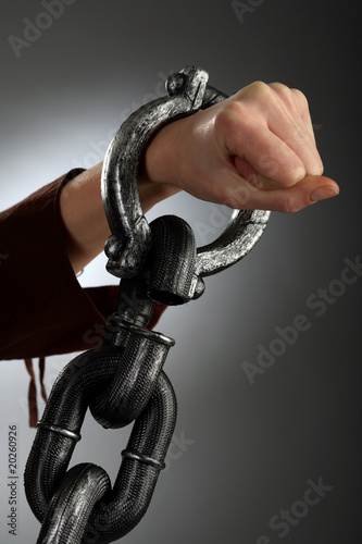 Woman hand in large handcuffs