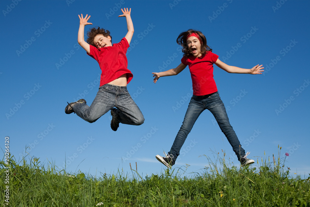Kids jumping, running against blue sky Kids jumping, running against blue sky