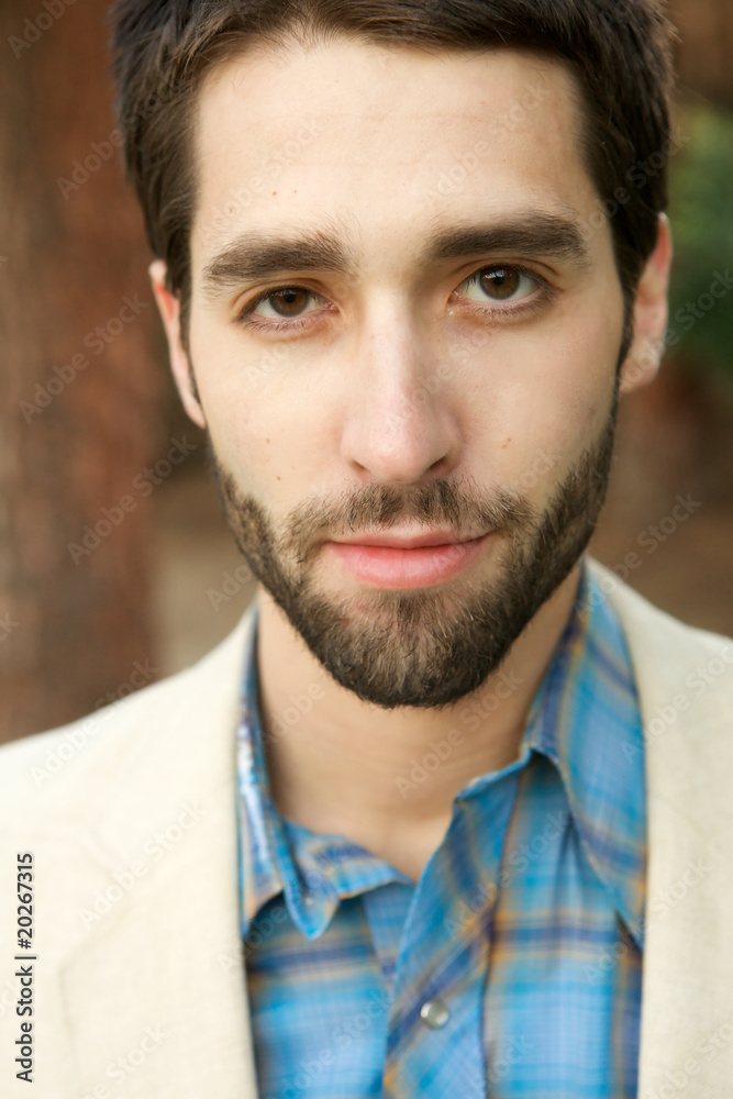 Fototapeta premium Attractive Young Man looking sternly at camera