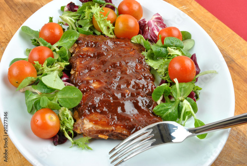 some marinated organic rib on healthy salad
