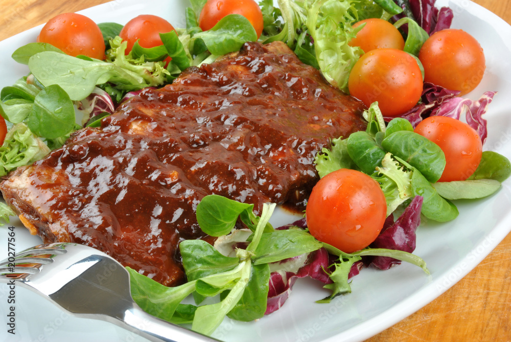 some marinated organic rib on healthy salad some marinated organic rib on healthy salad