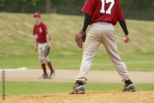 Pitcher and third baseman during a baseball game.