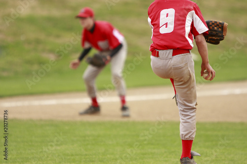Pitcher and third baseman during a baseball game.