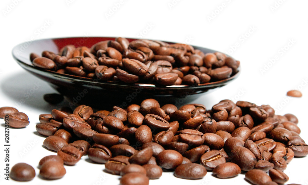 Coffee beans in a saucer.
