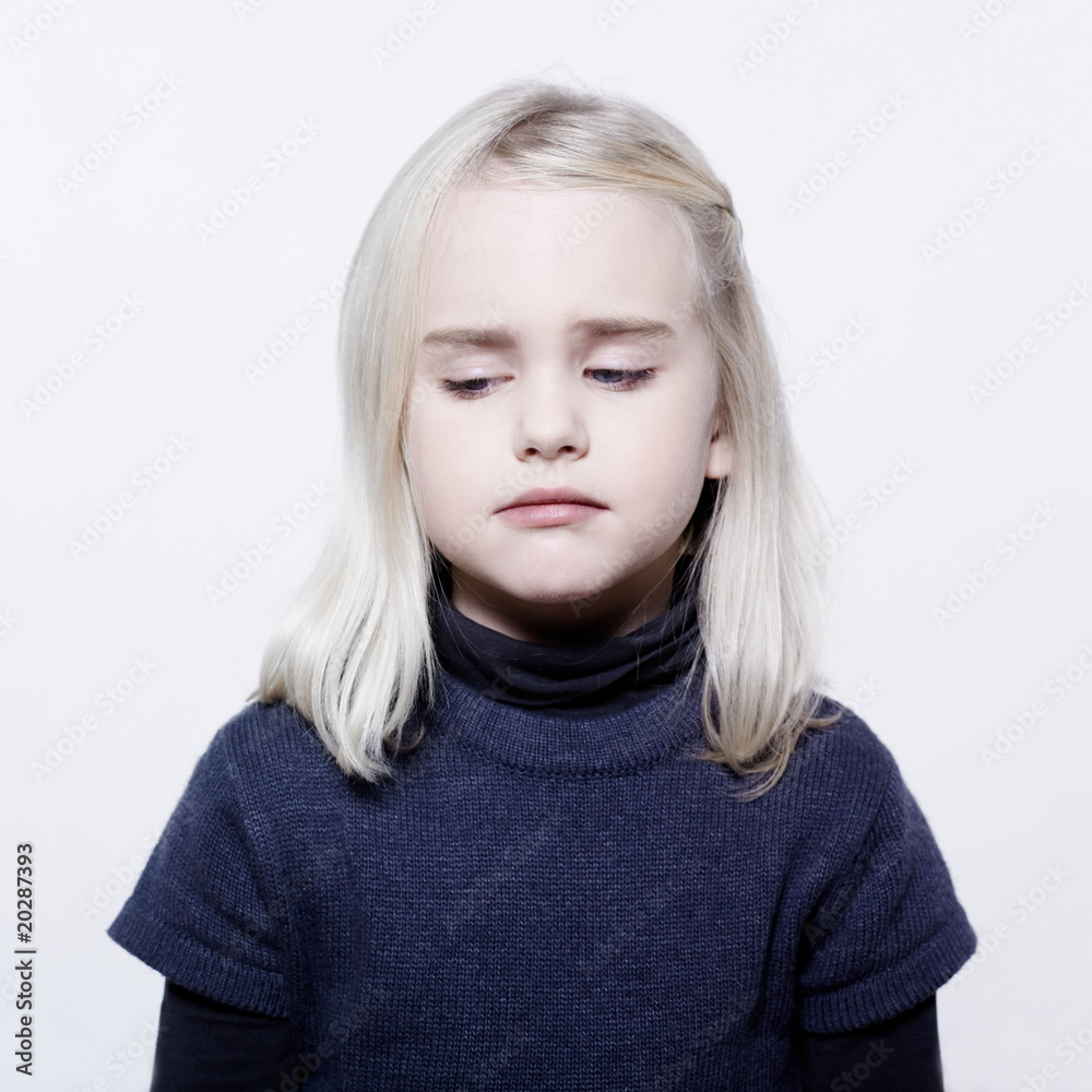 studio portrait of a caucasian cute sulk litle girl