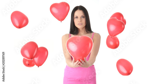 Beautiful young woman with red heart balloon