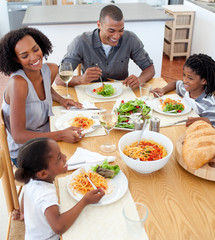 Smiling afro american family dining together