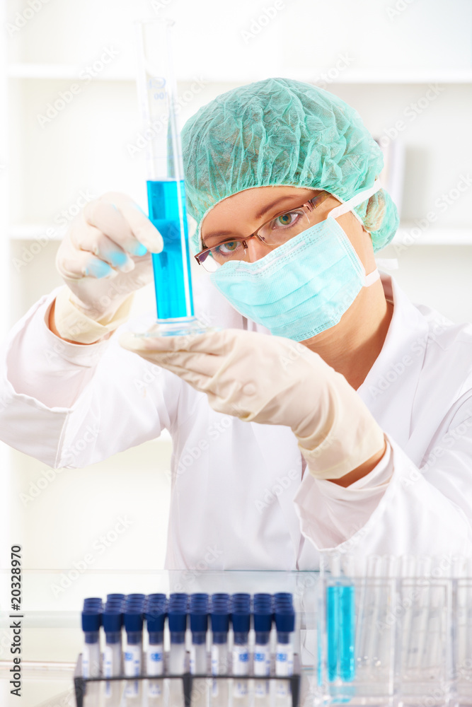 Closeup of a female researcher holding up a test tube Closeup of a female researcher holding up a test tube