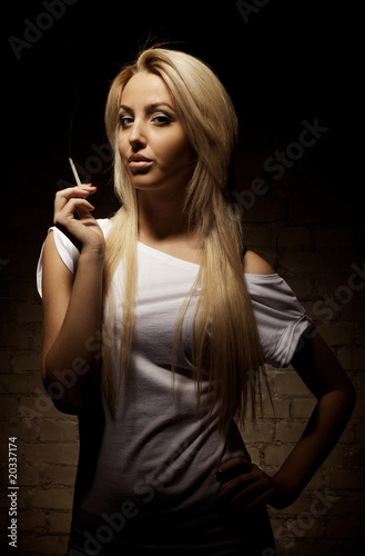 Portrait of young blond woman with a cigarette