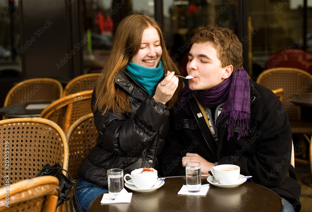 Happy romantic couple in a Parisian street cafe
