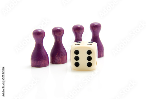 Four purple wooden pawns with dice over white background