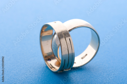 Gold rings on blue background macro