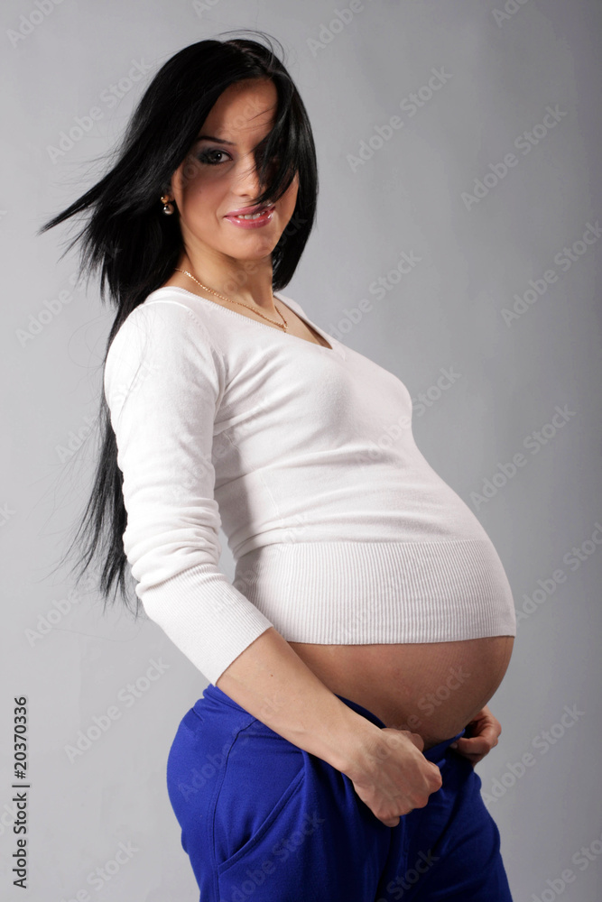 beautiful pregnant woman in a white sweater beautiful pregnant woman in a white sweater