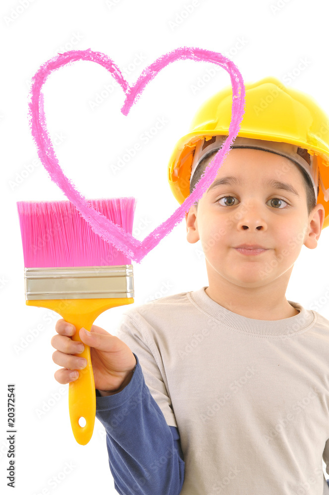 Cute boy wearing yellow helmet painting pink heart Cute boy wearing yellow helmet painting pink heart