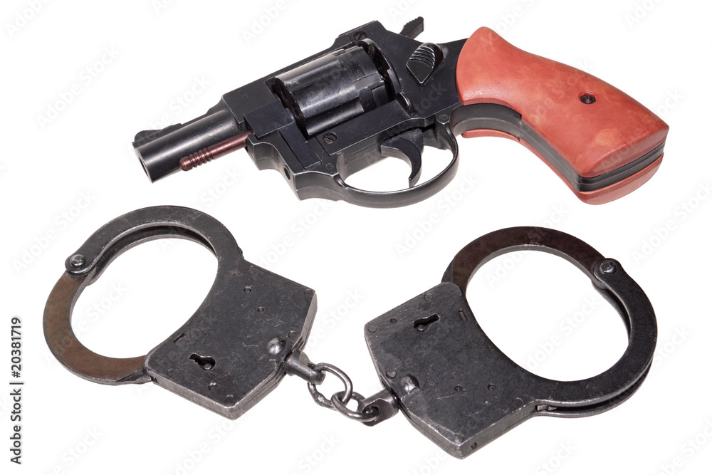 Black handcuffs and revolver isolated on white background Black handcuffs and revolver isolated on white background