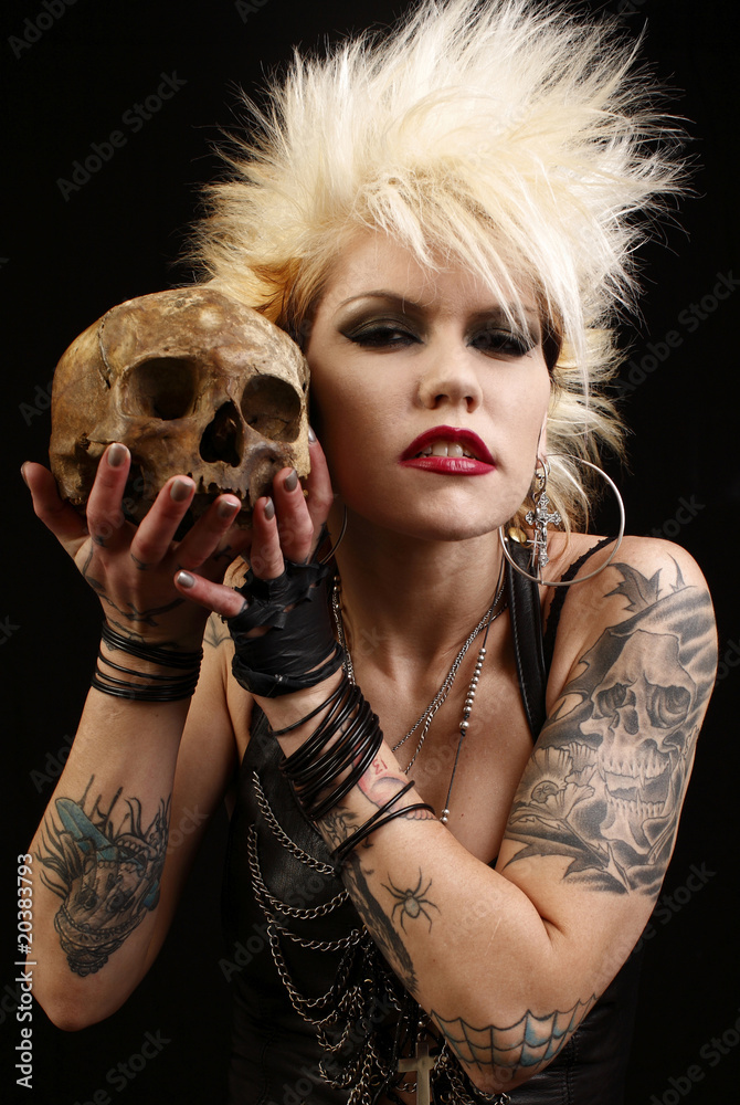 A sexy punk rocker woman with two automatic pistols. Stock Photo