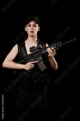young and attractive woman holding an assault rifle