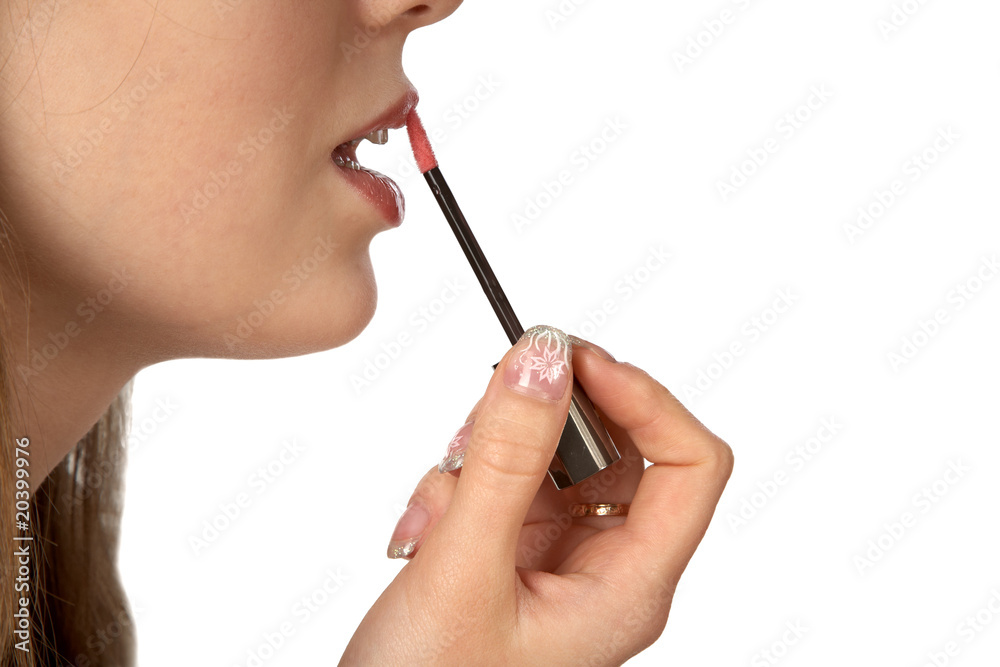 The girl painting lips isolated