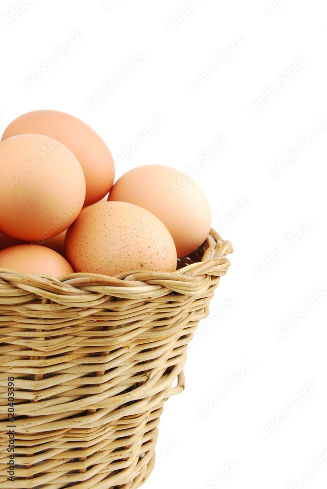 Close-up of eggs in a wicker basket on white Close-up of eggs in a wicker basket on white