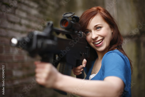 Sexy young woman with assault rifle
