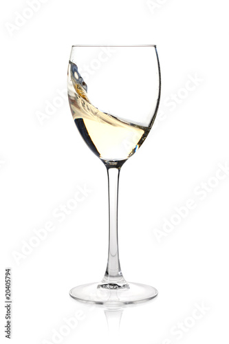 Splashing white wine in a glass