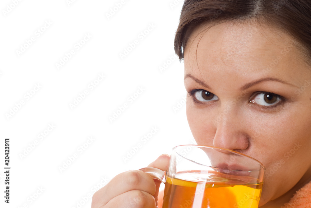 woman drinking tea in an orange smock with a white woman drinking tea in an orange smock with a white