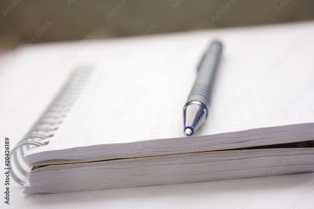Pen lying on a notebook Pen lying on a notebook