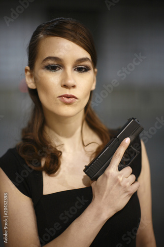 Young woman with pistol