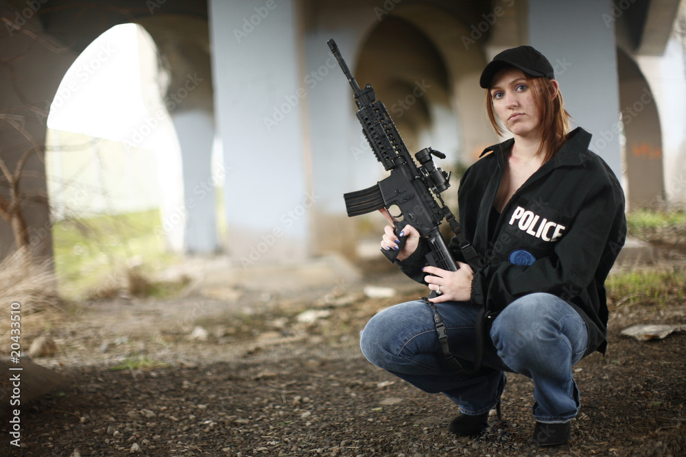 Female police officer with gun. Female police officer with gun.