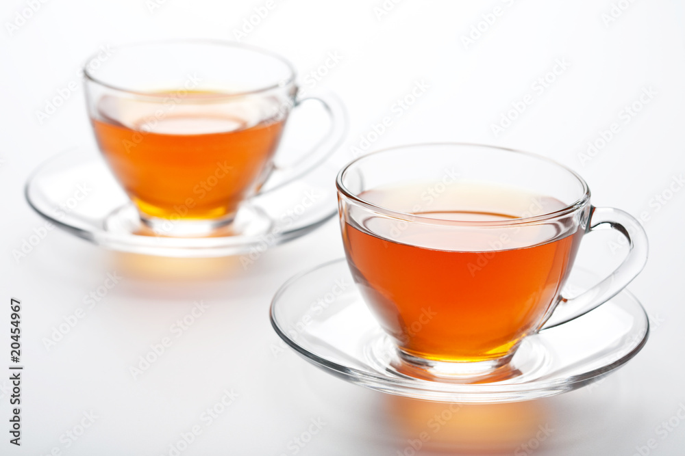 two cups of tea over white background