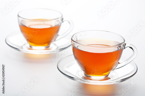 two cups of tea over white background