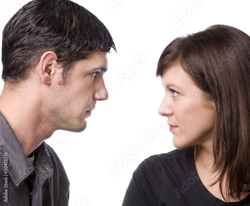Attractive couple facing each other in profile