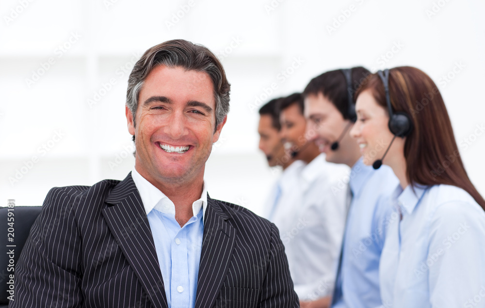 Confident manager presenting a call center Confident manager presenting a call center
