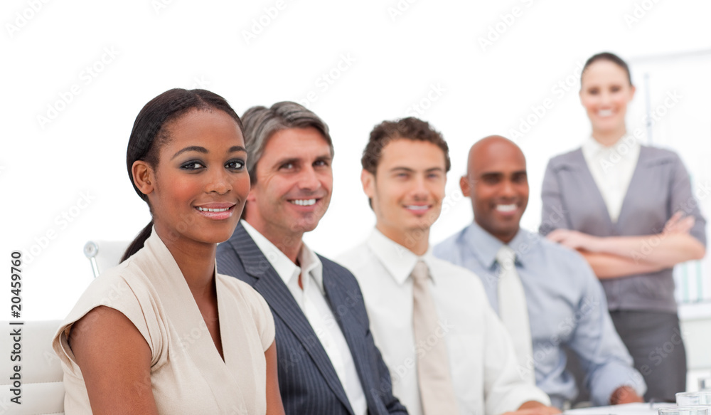 Positive business team smiling at the camera Positive business team smiling at the camera