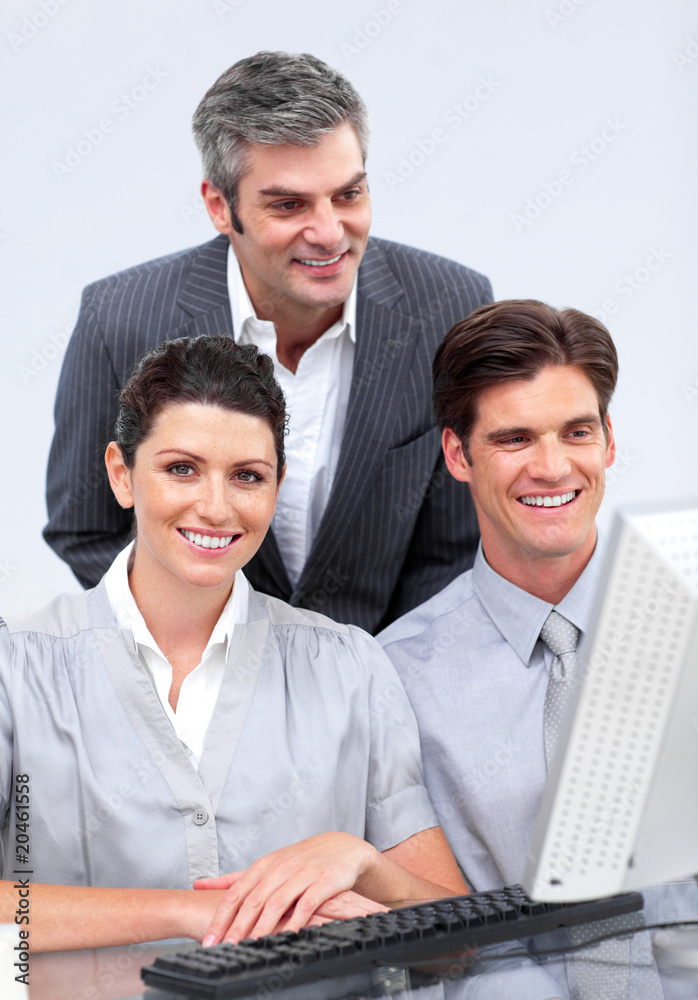 Charismatic businessteam working at a computer Charismatic businessteam working at a computer