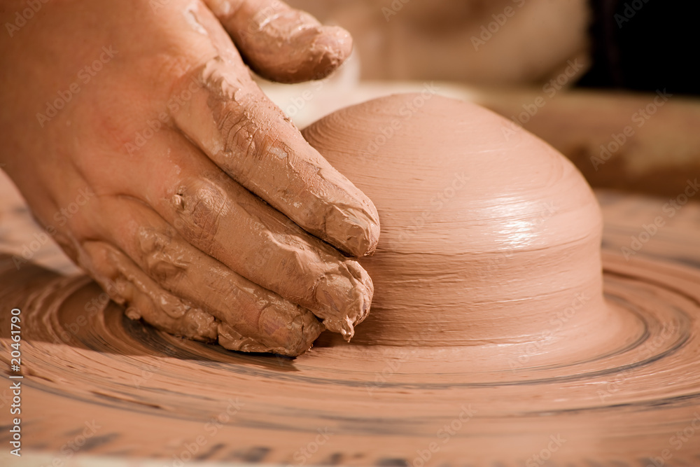 Hand shaping wedge of clay