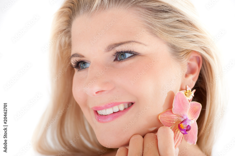 Young beautiful woman with healthy skin and orchid flower Young beautiful woman with healthy skin and orchid flower